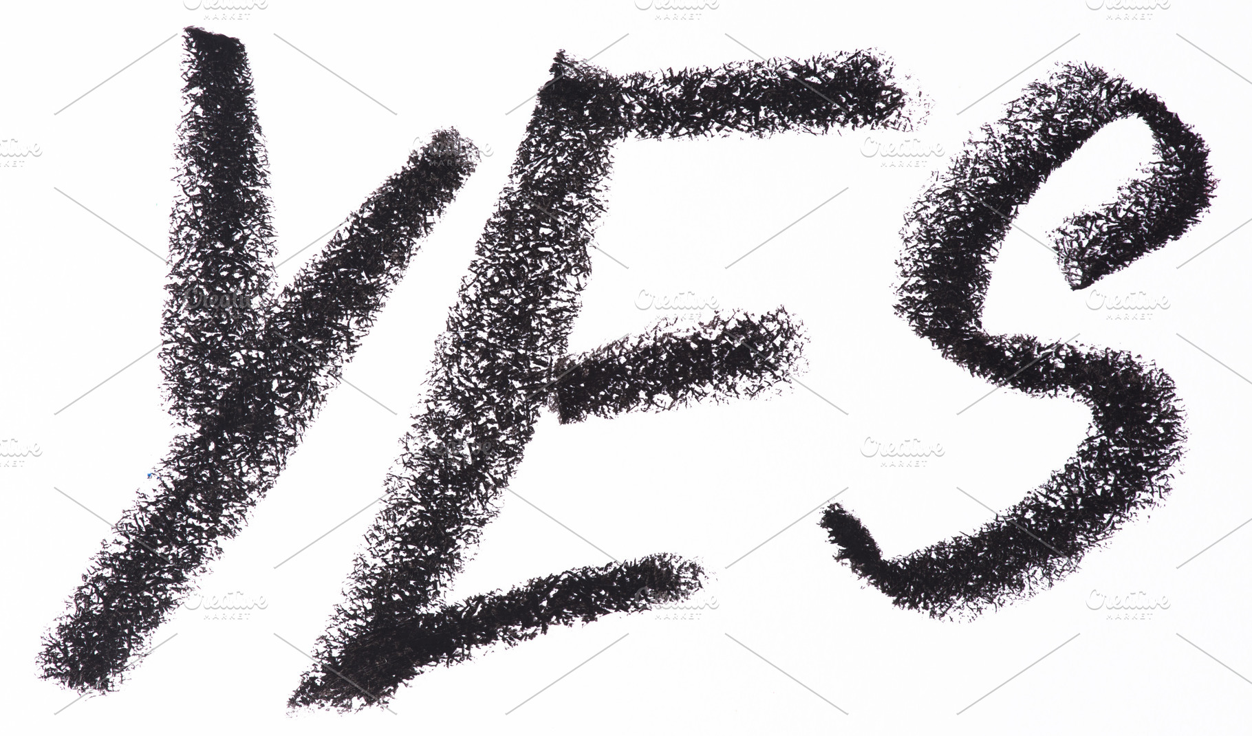 Word YES written in large, textured black crayon letters on a wh, an Abstract Photo by ndanko