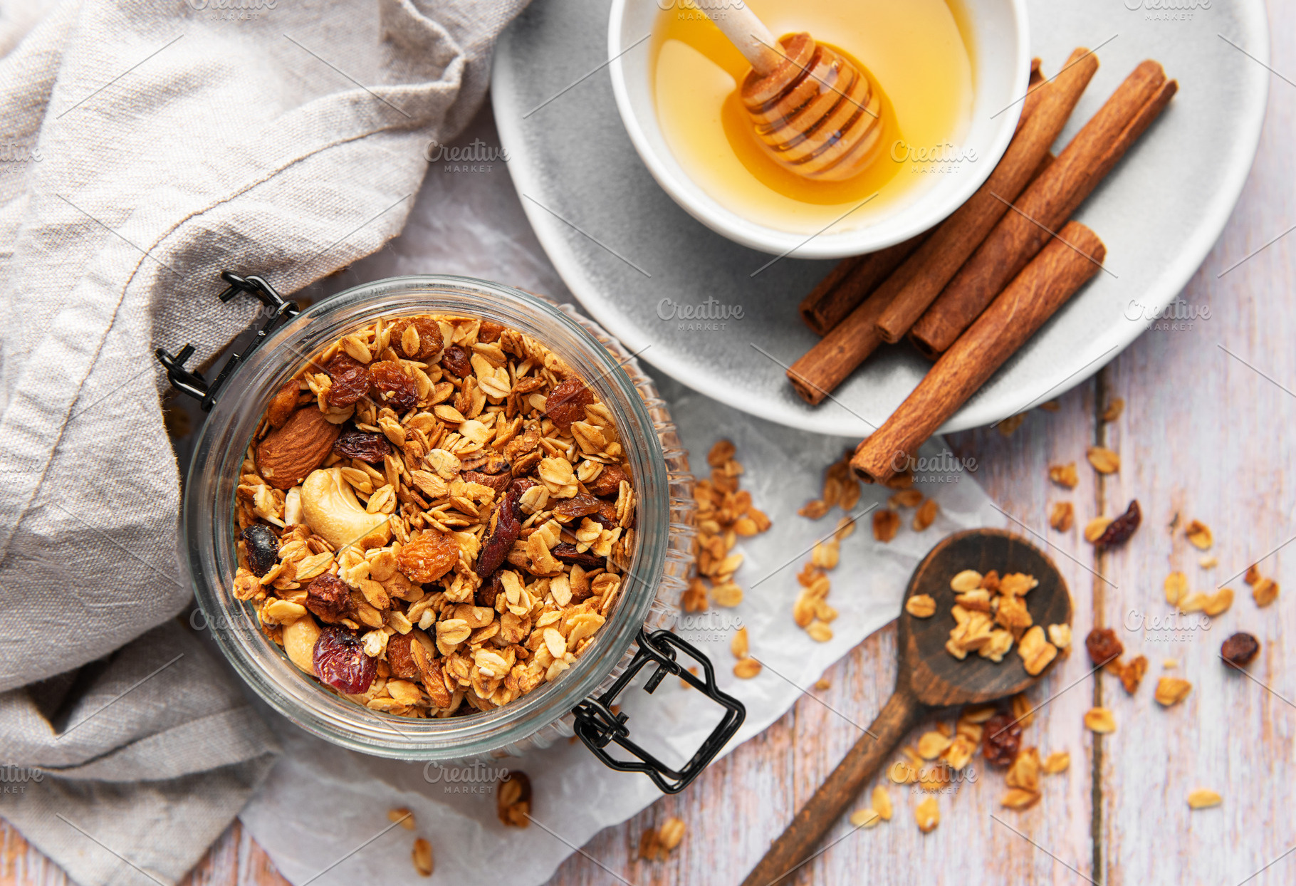Granola in jar with honey and cinnamon, a Food & Drink Photo by Olena Rudo