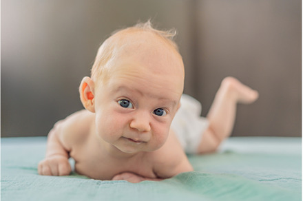One-month-old baby lying on tummy, a Person Photo by Elizaveta Galitskaya