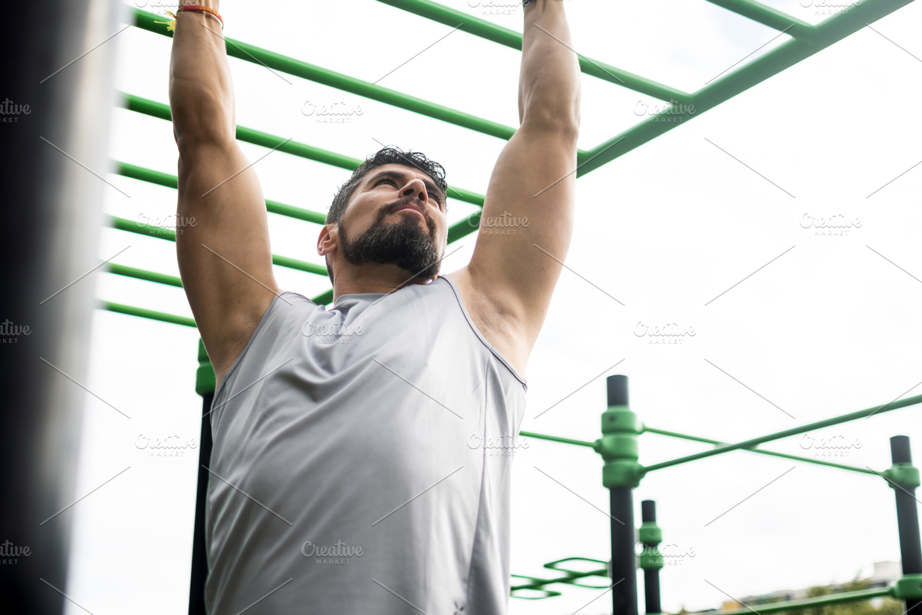 Young man doing pull-ups on bar in outdoor park workout, a Sports & Recreation Photo by etorres69