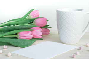 Desktop with pink tulips and mug