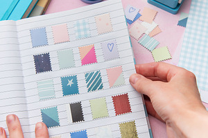 Hands creating a scrapbook with decorative paper punches, an Arts & Entertainment Photo by Olena Rudo
