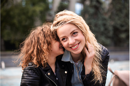 Mom and daughter are whispering, a Person Photo by oksix