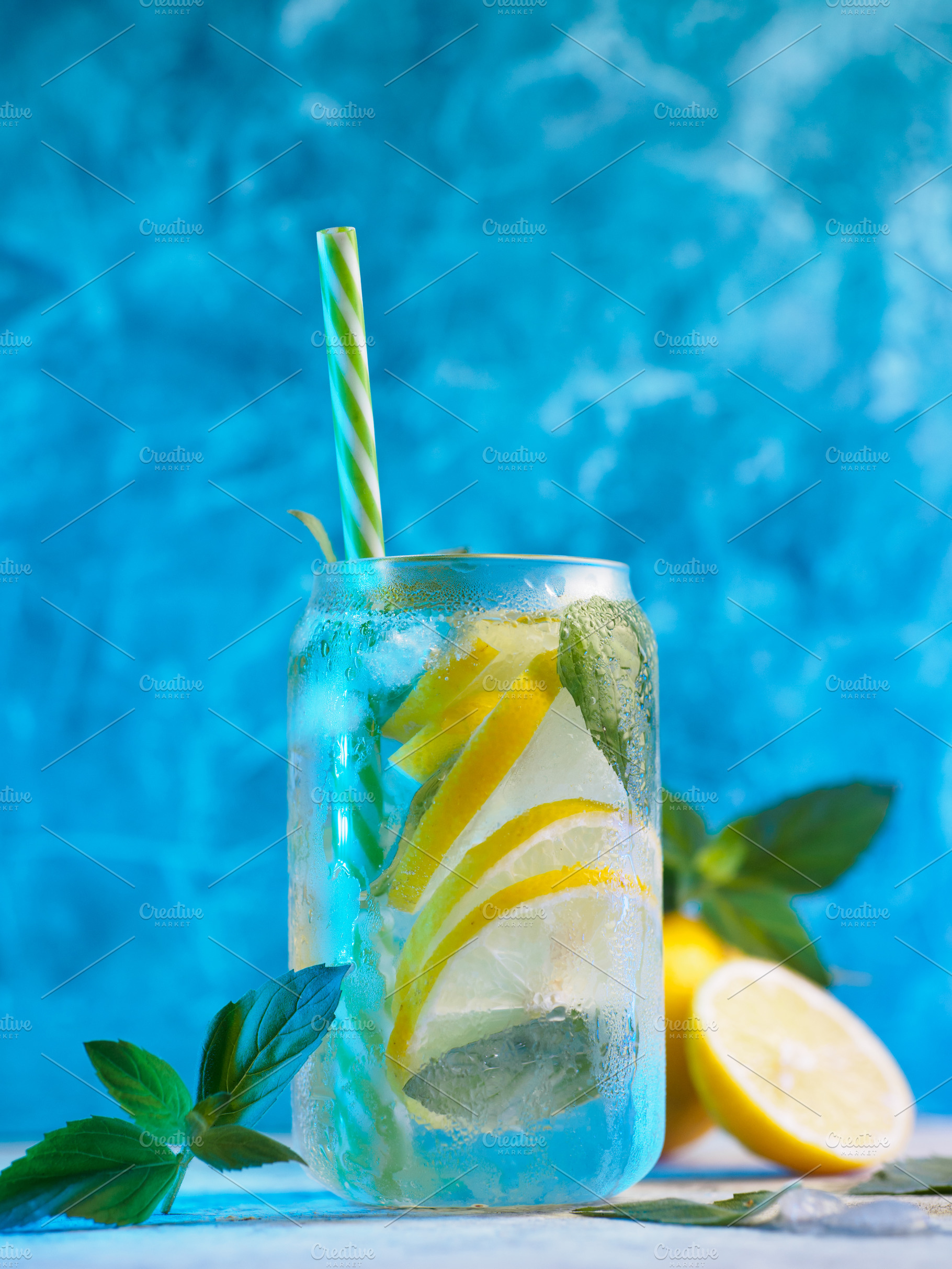 summer cold lemonade with lemon and mint, blue background., a Food & Drink Photo by PavelKant