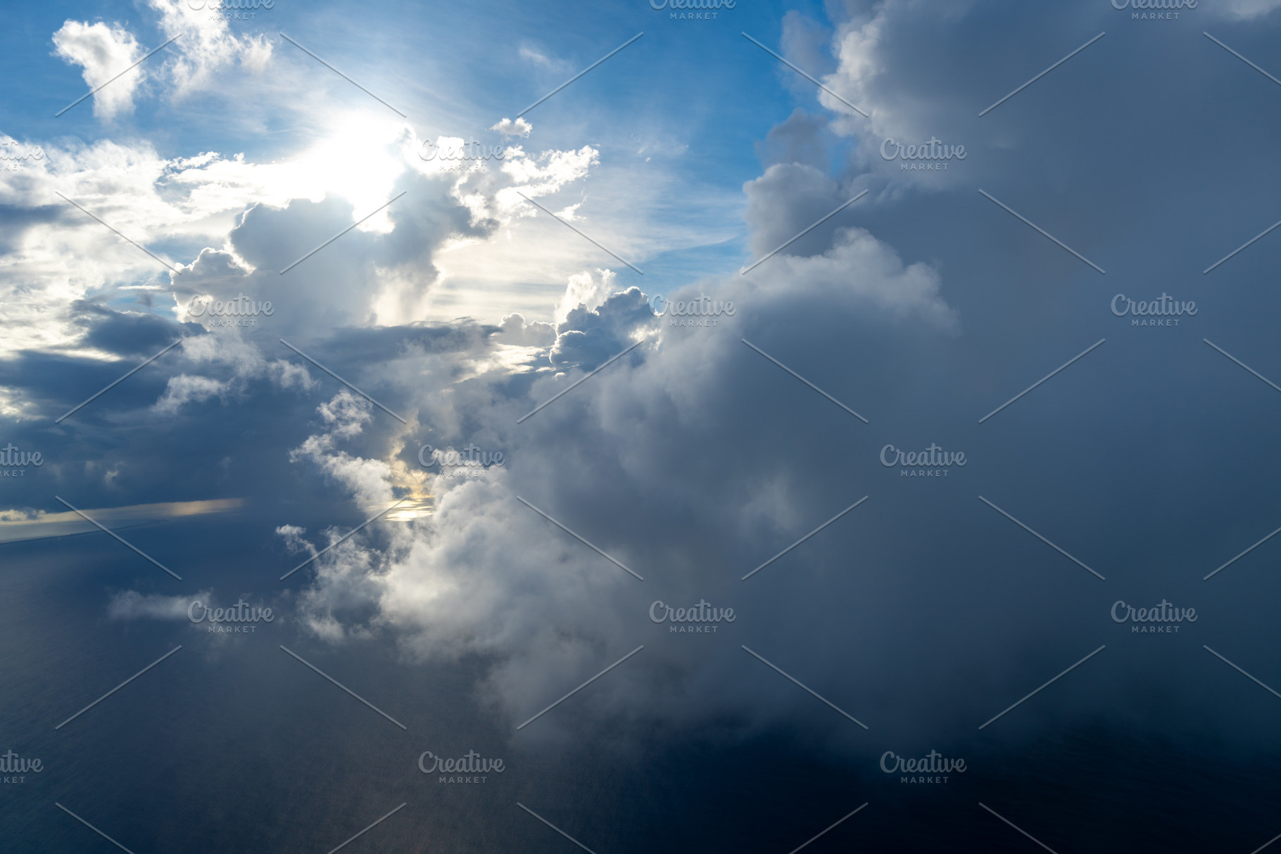 Dramatic sky with sunbeams and clouds seen from an airplane, a Nature Photo by GoodGoods