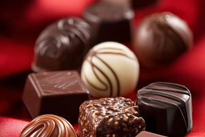 Assortment of gourmet chocolate truffles and bonbons arranging o, a Photo by Studio ANNA
