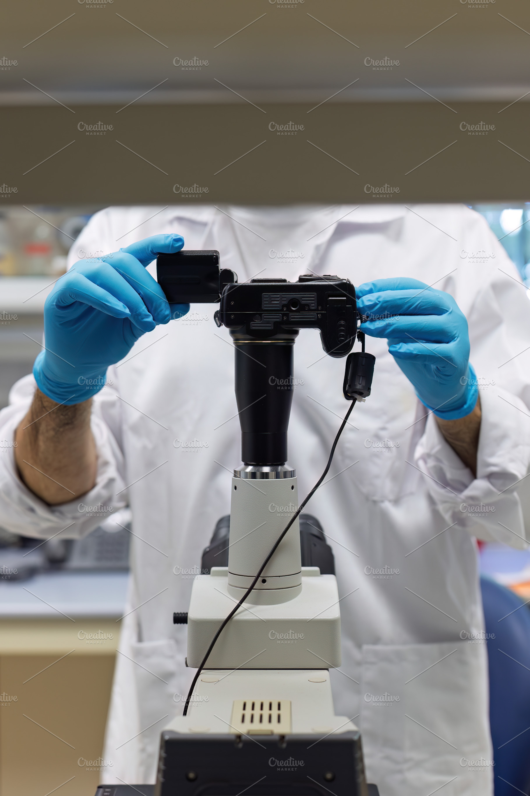 Technician connects digital camera t, a Health & Medical Photo by Perpis