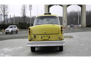A classic yellow taxi parked at a, a Transportation Photo by Media Whale Stock
