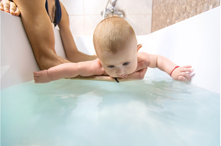 The father bathes the little baby, a Person Photo by yanadjana