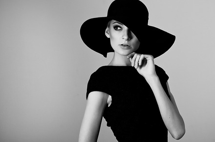 Woman retro fashion portrait featuring black, white, and hat