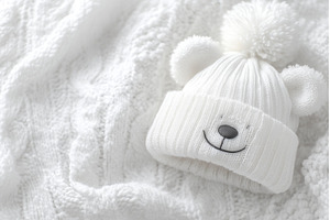 On the bed lies a white-clad baby, a Person Photo by ZinetroN