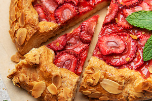 Delicious homemade strawberry galette with almond petals baking, a Food & Drink Photo by Olena Rudo