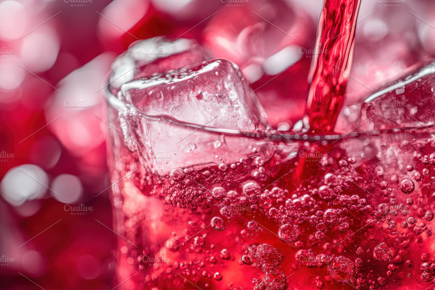 Cherry soda cascading over ice cubes, a Photo by Iftikhar Alam