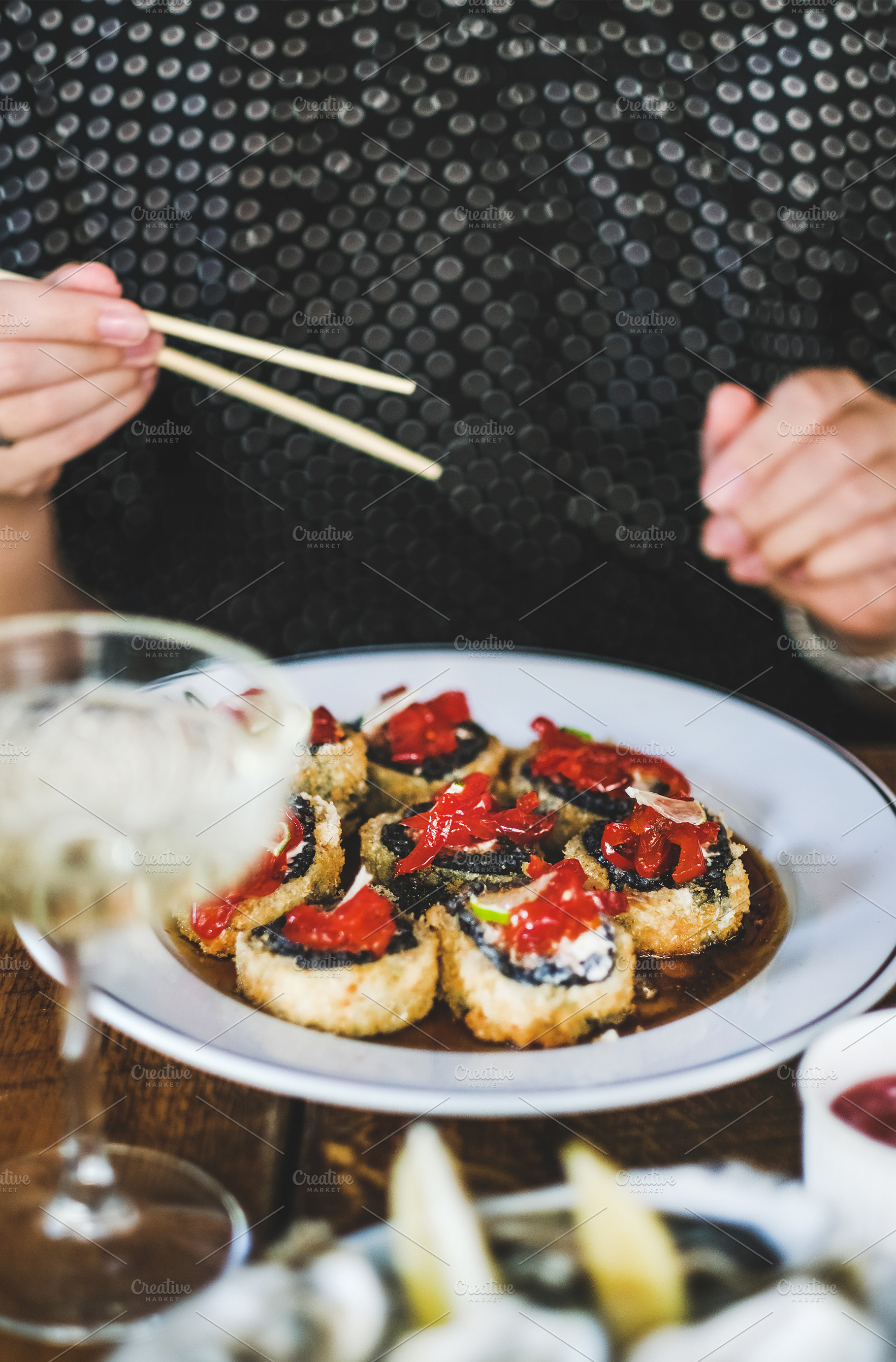 Girl eating baked susi maki with, a Food & Drink Photo by Foxys