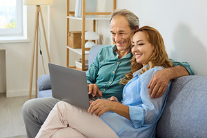Mature Couple Hugging with Laptop, a Person Photo by StudioRomantic
