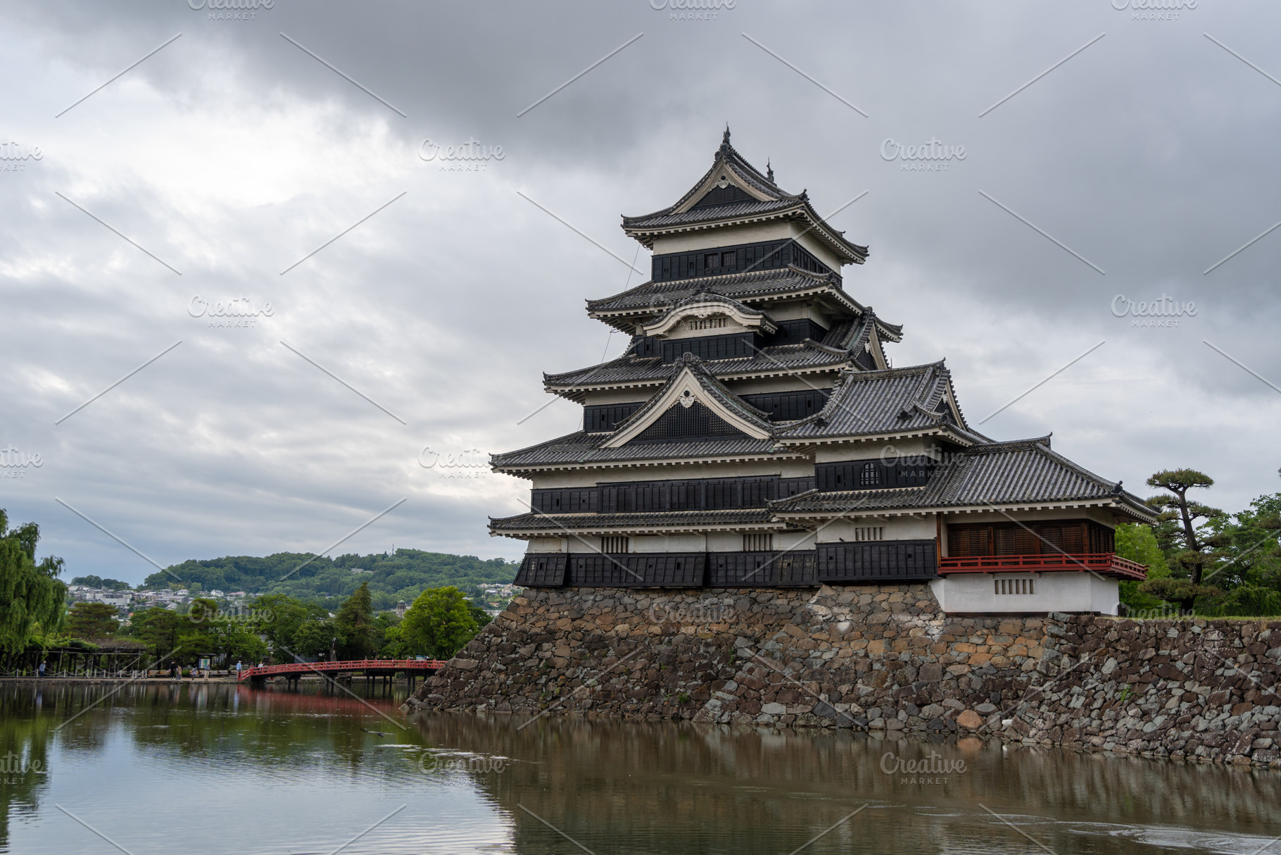 Historic Matsumoto Castle reflected in calm waters, Japan, a Nature Photo by GoodGoods