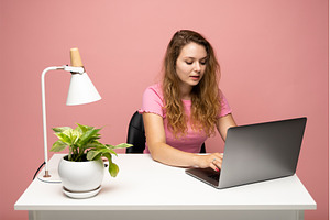 Woman working on laptop at white, a Person Photo by volodymyrshtun13795