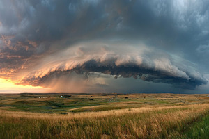 Dramatic storm clouds over rolling hills at sunset, a Nature Photo by AlyaAnd