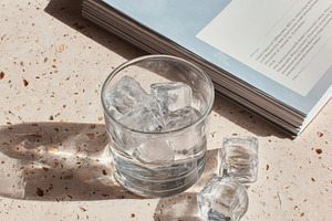 Ice cubes melting on terrazzo table, a Food & Drink Photo by Virgo Studio