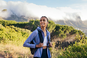 Smiling woman with backpack, a Sports & Recreation Photo by Artem Varnitsin