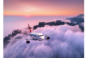 Commercial airplane flying over high, a Transportation Photo by den-belitsky