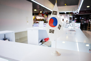 South Korean flag displayed on a table inside a bright modern interior, a Photo by AS photostudio
