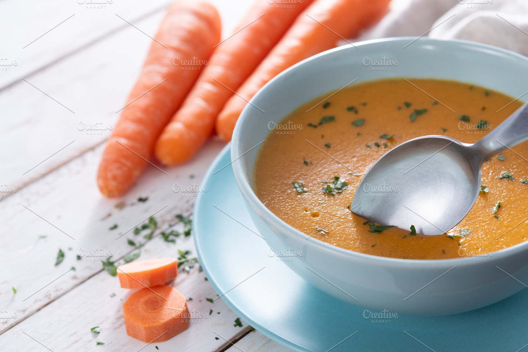 Creamy Carrot Soup in Blue Bowl on White Wooden Table, a Food & Drink Photo by etorres69