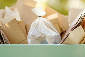 Garbage bin filled with plastic and paper waste in outdoor park, a Photo by Dvoevnore photos