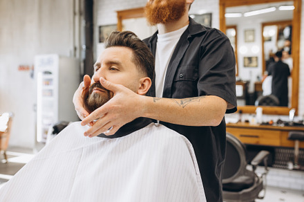 Man getting haircut at the barbershop. Professional barber at work process. Bea, a Person Photo by Volodymyr Melnyk