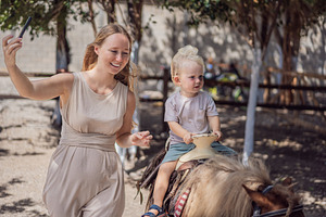 Mother captures a phone selfie, a Person Photo by Elizaveta Galitskaya