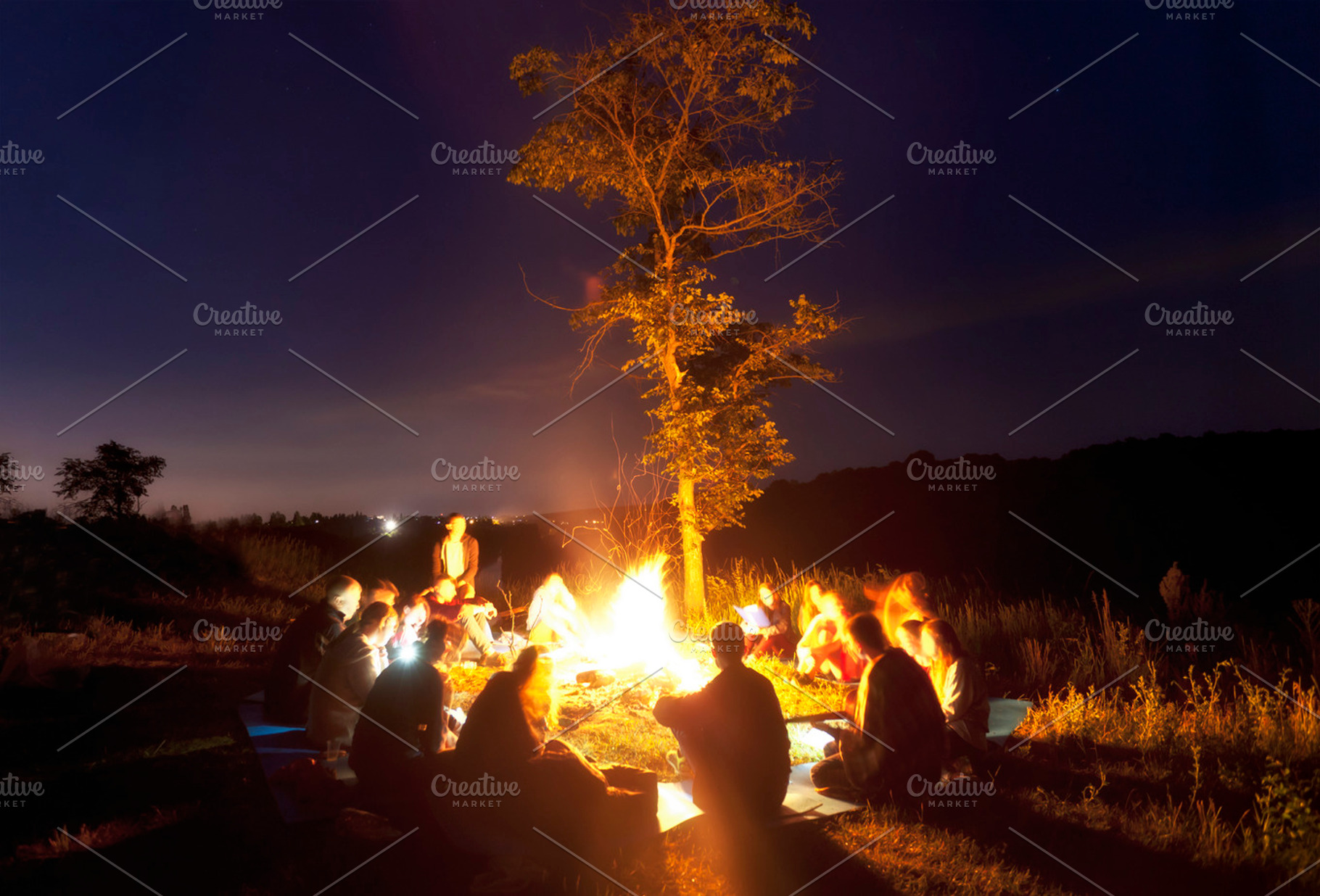 People sitting around the bonfire, a Background Photo by Olegkalina