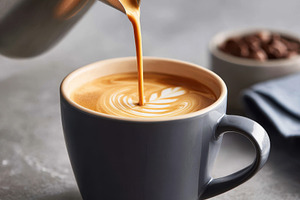 Pouring latte art into a coffee cup, a Food & Drink Photo by AlyaAnd