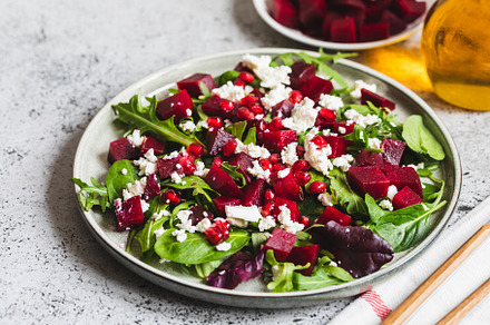 Arugula, Beet and cheese salad with pomegranate and dressing on, a Food & Drink Photo by Ivanna