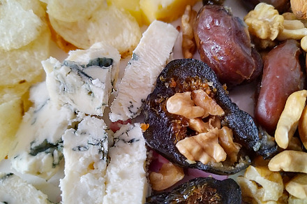 Plate of food, including cheese, nuts, and other items., a Food & Drink Photo by DanFLCreativo