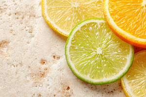 Fresh citrus slices on textured stone, a Food & Drink Photo by AlyaAnd