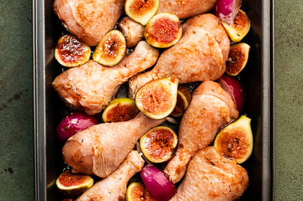 Raw chicken legs, drumsticks with sweet figs and red onions in b, a Food & Drink Photo by 5PH