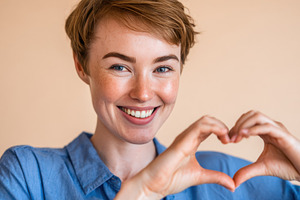 Woman forming heart with hands, a Photo by Beautiful things