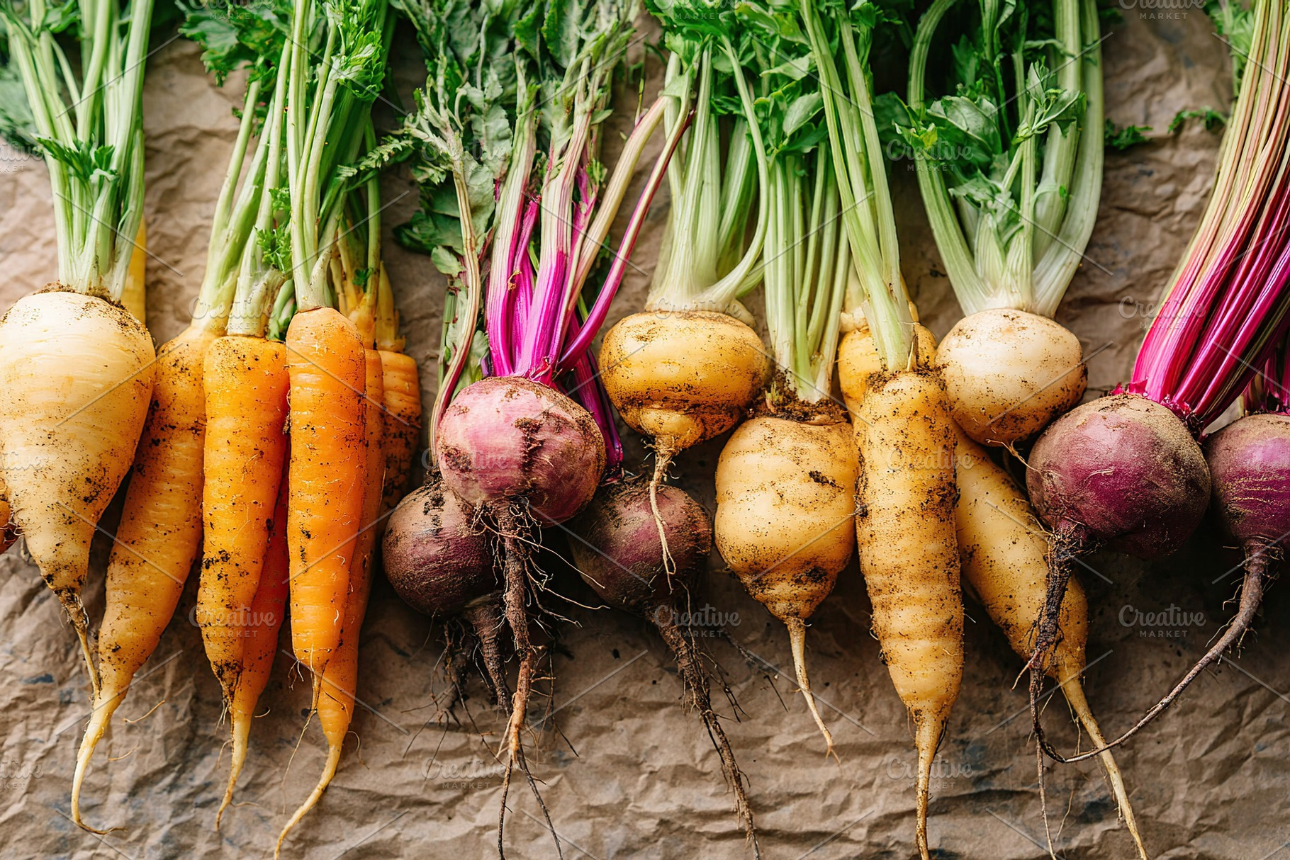 Fresh seasonal root vegetables showcased on brown paper background in natural l, a Food & Drink Photo by AlyaAnd