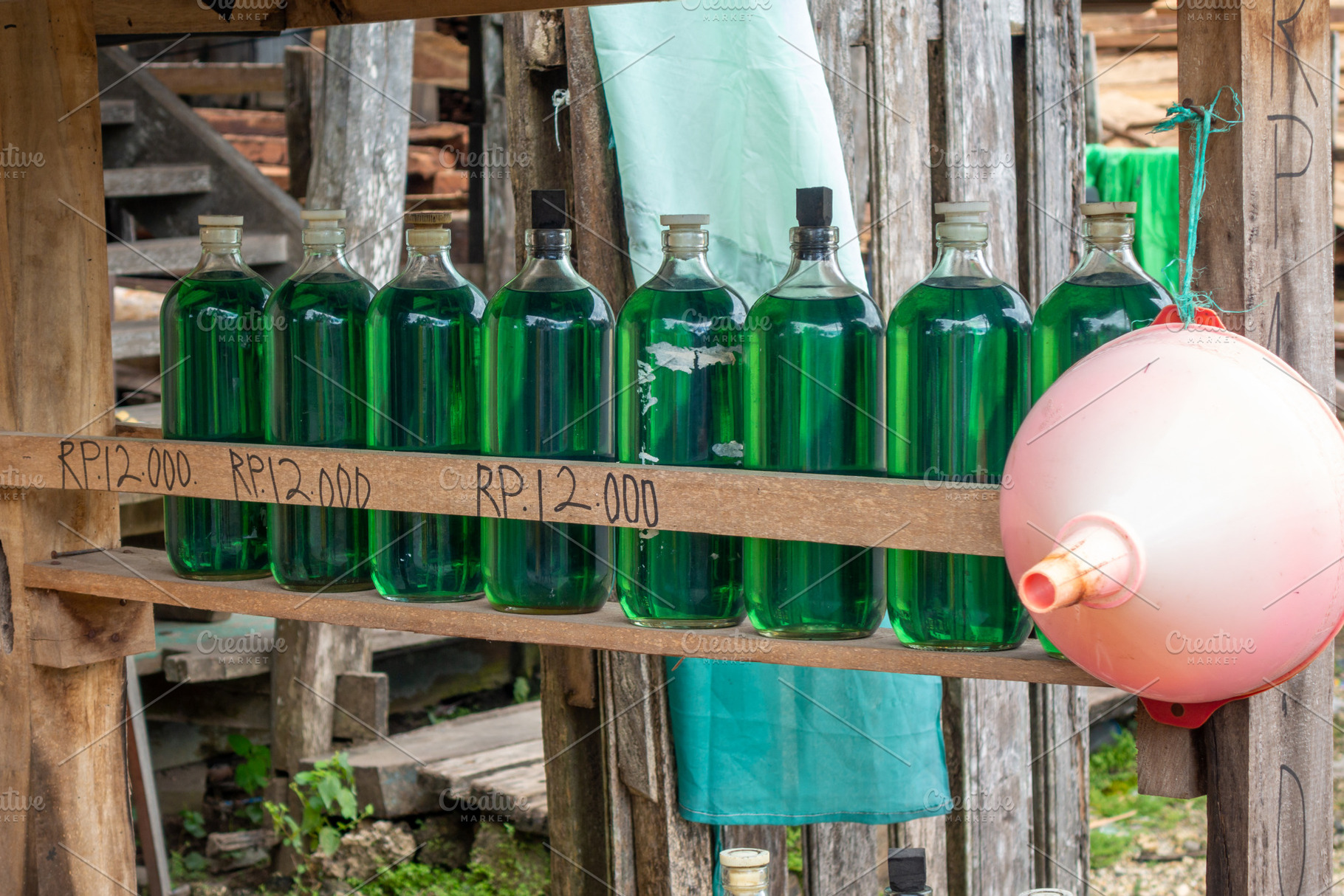 Bottled gasoline for sale along roads in Sulawesi, Indonesia, an Architecture Photo by GoodGoods