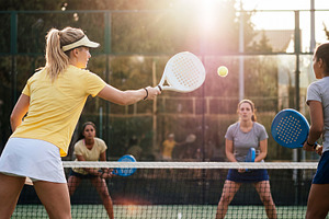 Female padel players during doubles match on outdoor court in da, a Sports & Recreation Photo by Volff