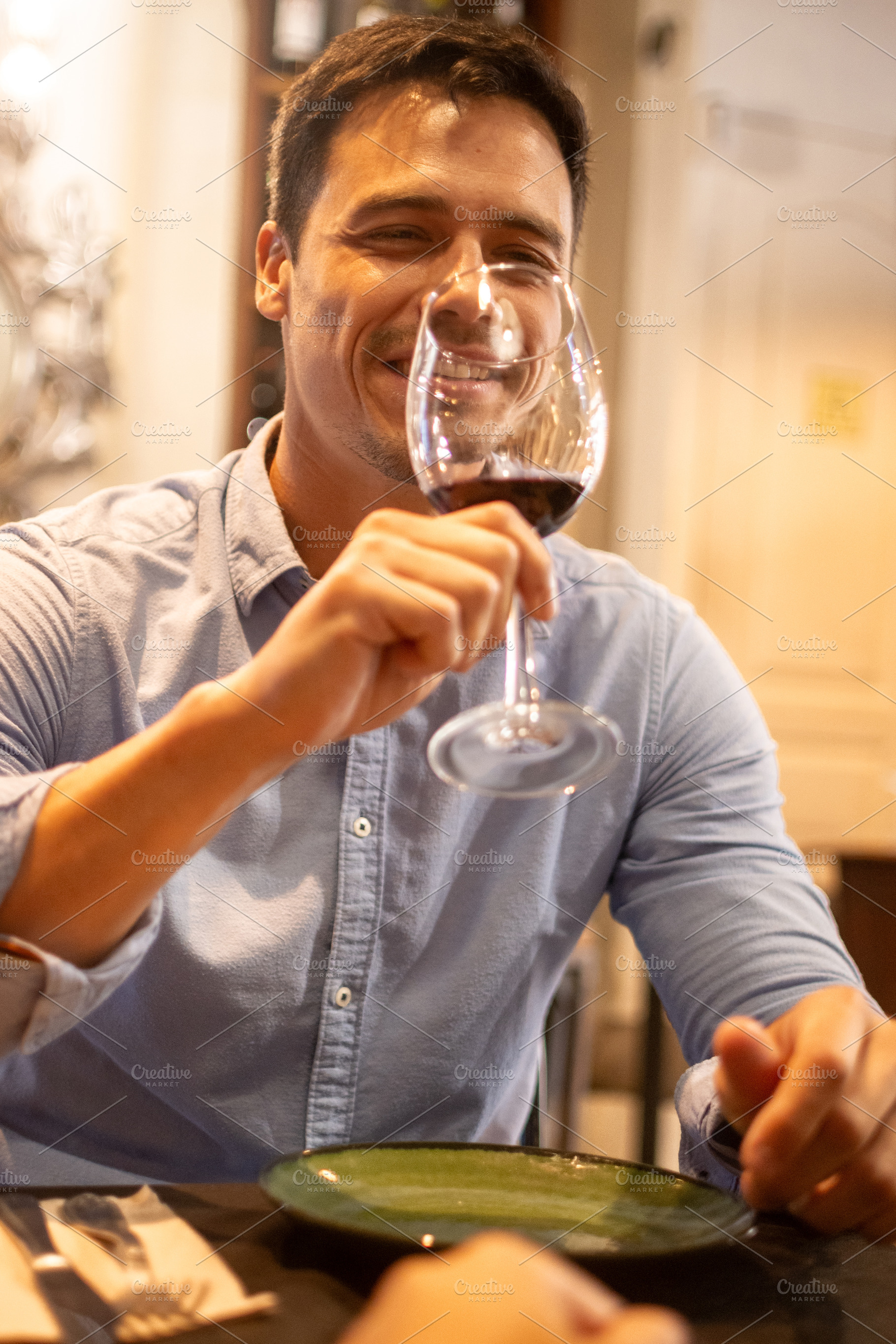 Man enjoying a glass of red wine during restaurant dinner, a Person Photo by etorres69