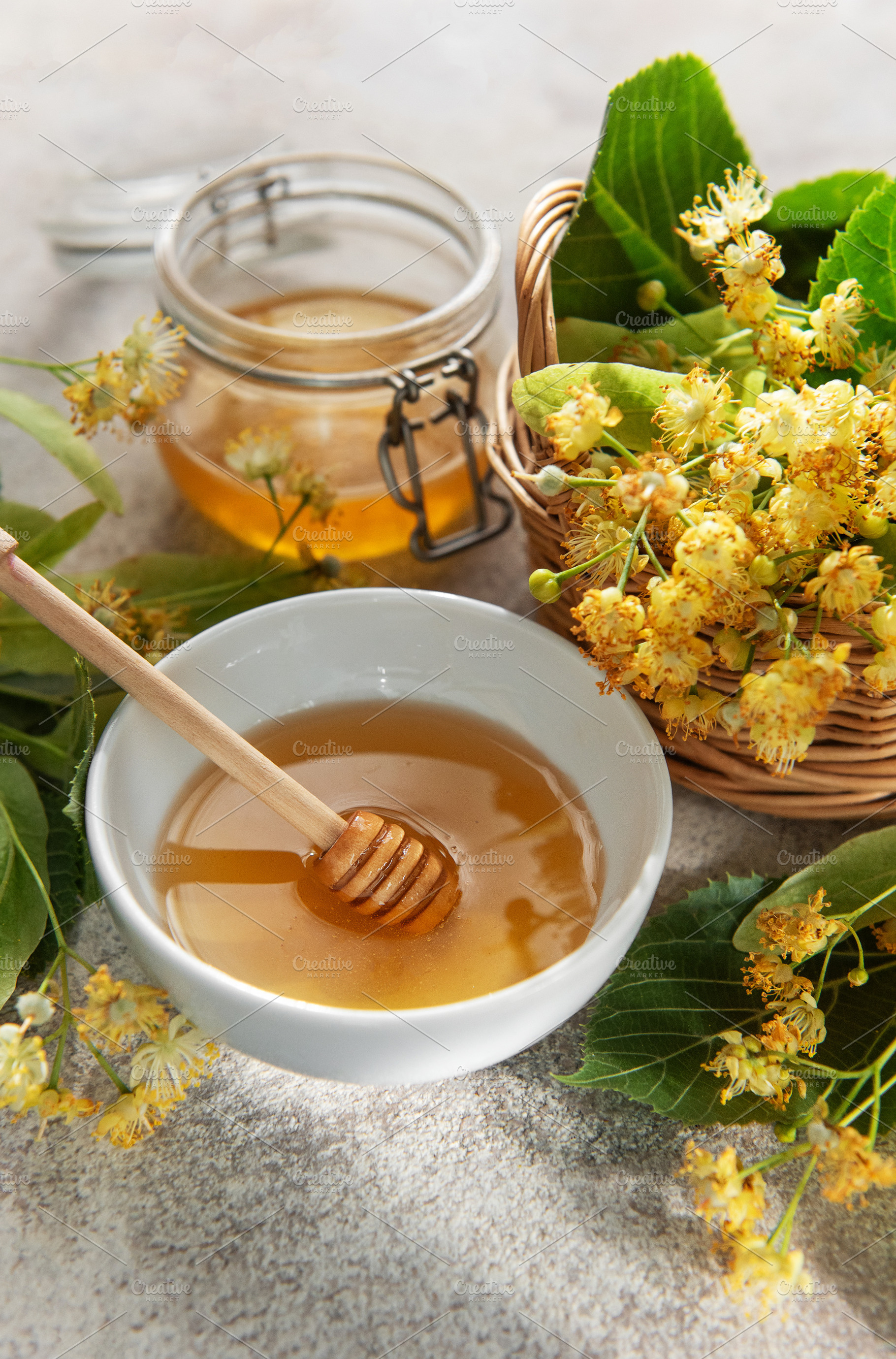 Linden honey in bowl with medicinal flowers, a Food & Drink Photo by Olena Rudo