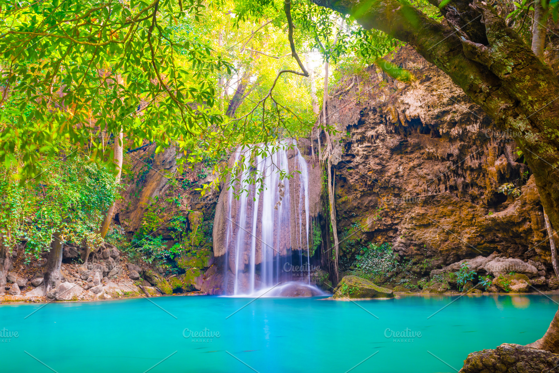 Tropical waterfall with emerald lake in jungle forest, a Nature Photo by Vapi