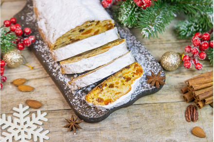 Stollen Christmas cake on the table, a Holiday Photo by yanadjana