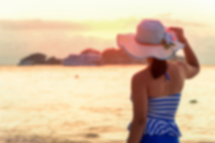 Girl on the beach at sunrise containing blur, blurred, and beach, a Person Photo by yongkiet jitwattanatam