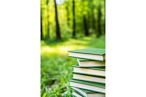 Green books stacked in sunlit forest, a School & Education Photo by Lermont51