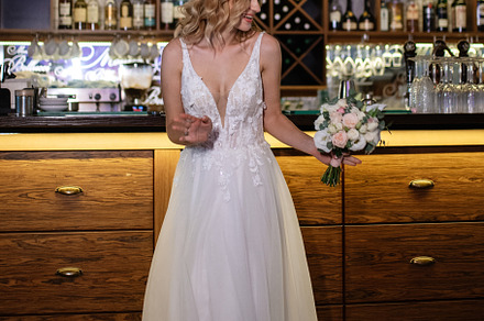 blonde bride in a bar near with a wedding bouquet, a Person Photo by Weddings, People, Travel