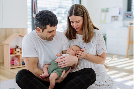 Happy parents cuddling with their, a Person Photo by HalfPoint