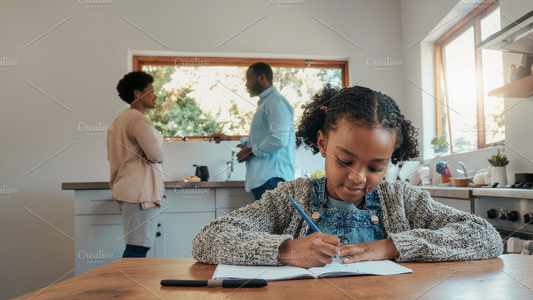 Child writing homework at kitchen table, a Person Photo by DanFLCreativo