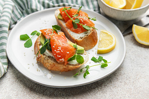 Smoked salmon bruschetta with cream cheese and avocado, a Photo by Olena Rudo